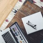 turned on MacBook Pro near black framed eyeglasses