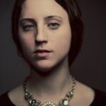 portrait photography of woman in black top