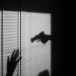 silhouette of person on window
