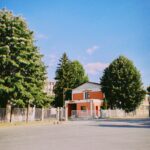 green trees near red and white house during daytime