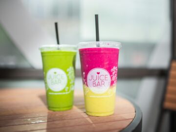 two green and yellow plastic cups