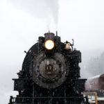 black train on railway at daytime