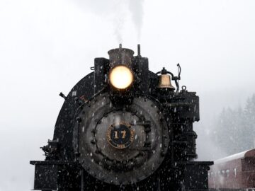 black train on railway at daytime