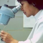 man in white dress shirt holding gray and silver steel tool