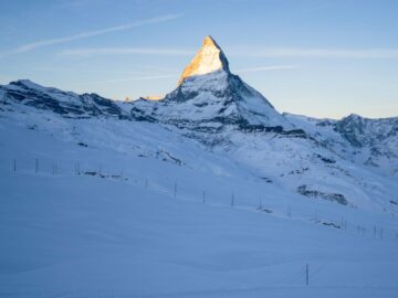 Capturing the majestic Matterhorn in Zermatt with a serene snow-covered landscape under a clear winter sky.