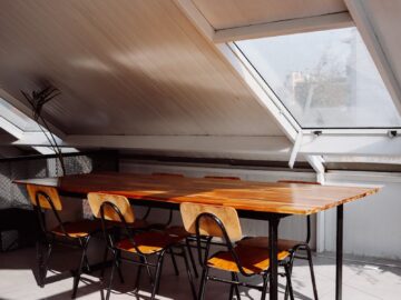 Cozy attic dining area in Santiago with minimalistic design and natural lighting.
