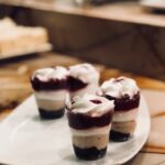 Layered berry cream parfaits on a plate, perfect for a sweet indulgence.