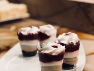 Layered berry cream parfaits on a plate, perfect for a sweet indulgence.