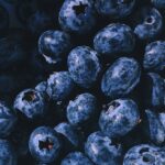 A vibrant close-up of a heap of fresh, juicy blueberries, showcasing their natural beauty and nutritional appeal.