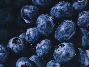 A vibrant close-up of a heap of fresh, juicy blueberries, showcasing their natural beauty and nutritional appeal.
