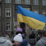 People gather in Wałbrzych, Poland, waving the Ukrainian flag in a show of solidarity.