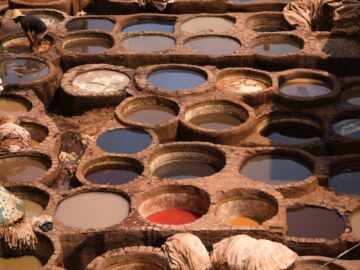 High angle view of a colorful, busy tannery with workers in Morocco.