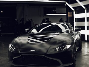 Elegant and luxurious black sports car showcased in a modern indoor setting.