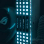 Close-up view of glowing computer RAM modules with blue illumination, highlighting technology.