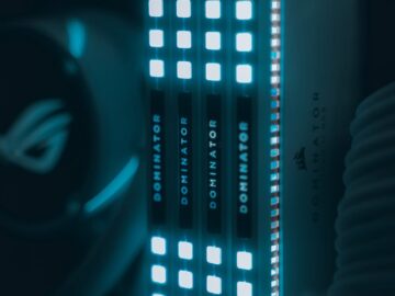 Close-up view of glowing computer RAM modules with blue illumination, highlighting technology.