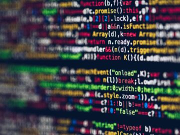 Vivid, blurred close-up of colorful code on a screen, representing web development and programming.