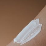 A detailed view of moisturizing cream applied on smooth human skin.