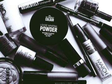 Elegant monochrome flatlay showcasing a collection of beauty products and cosmetics.