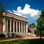 Historic neoclassical university library with columns on a sunny day.
