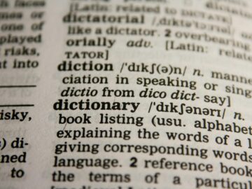 Detailed close-up view of a dictionary page highlighting the word 'dictionary' and its definition.
