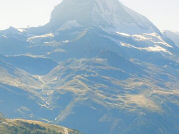 A breathtaking view of the Matterhorn mountain peak in Zermatt, Switzerland under a clear blue sky.