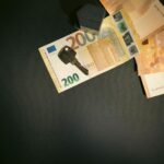 Flat lay of a house key on Euro bills representing real estate investment and finance.