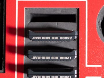 High-angle view of 120GB and 240GB hard disk drives in a foam-lined red protective case.