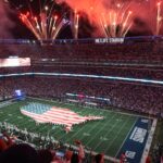 An exciting NFL match day at MetLife Stadium with fireworks and USA flag display.