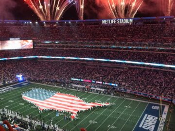 An exciting NFL match day at MetLife Stadium with fireworks and USA flag display.