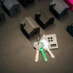 Miniature house models and keys symbolize real estate investment and housing market.