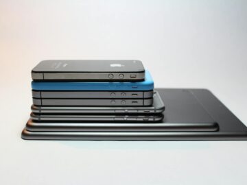 Stacked modern smartphones and tablets showcasing sleek design. Perfect tech background.