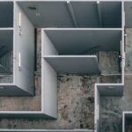 Aerial view of a complex indoor labyrinth made of concrete walls.