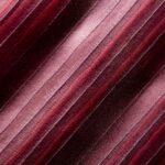 Close-up of maroon fabric with a textured striped pattern, ideal for textile design backgrounds.