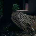 A dimly lit stone marker with bold lettering, creating a mysterious and moody atmosphere.