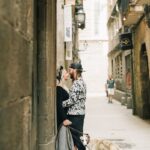 A couple shares an intimate moment on a city street with their dog.
