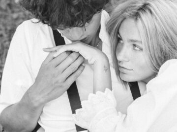 Emotional black and white portrait of a couple embracing in nature.