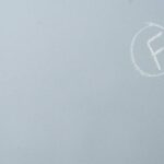 Chalk-written F grade encircled on a textured light blue surface.