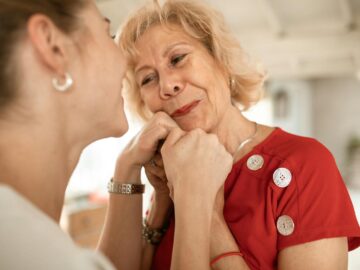A touching scene showing affectionate connection between two women indoors.