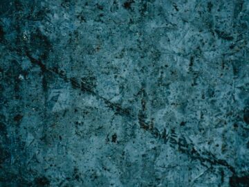 A detailed vintage grunge texture with dark tones, perfect for artistic backgrounds and design elements.