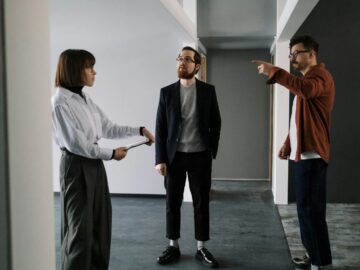 Colleagues in an office having a focused discussion about project plans.