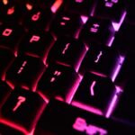 Vibrant close-up of a modern RGB backlit mechanical keyboard with glowing keys.