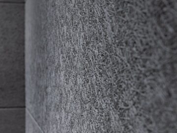 Detailed view of a gray textured wall surface highlighting modern architectural design.
