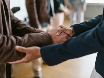 Close-up of two businesspeople shaking hands, symbolizing agreement and partnership.