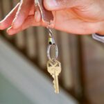 Close-up of a hand holding a key, symbolizing new homeownership or rental.