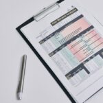 A hair mineral analysis report displayed on a clipboard photographed from above, with a pen nearby.