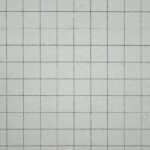 Close-up of a squared white grid notebook paper, perfect for educational or office themes.