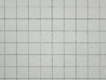 Close-up of a squared white grid notebook paper, perfect for educational or office themes.