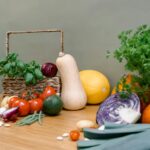 Assorted fresh vegetables and herbs on a wooden table enhancing culinary inspiration.