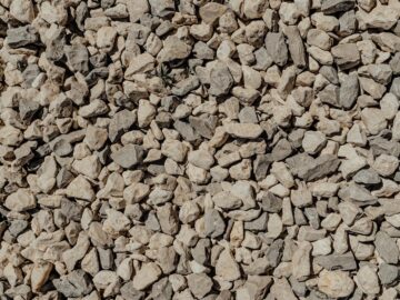 Detailed close-up of crushed gravel stones showcasing natural texture and rough surface.