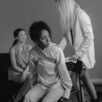 Black and white photo of diverse women discussing social issues, emotional portrayal.